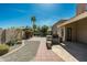 A back patio with a built-in grill and landscaped walkway invites outdoor living and entertainment at 14401 N 60Th Pl, Scottsdale, AZ 85254