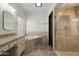 Bright bathroom with double vanity, soaking tub, glass-enclosed shower, and neutral tile at 14401 N 60Th Pl, Scottsdale, AZ 85254