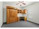 Cozy bedroom featuring carpeted floors, built-in shelving, and shuttered windows at 14401 N 60Th Pl, Scottsdale, AZ 85254