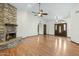 Spacious living room featuring a stone fireplace, hardwood floors, and lots of natural light at 14401 N 60Th Pl, Scottsdale, AZ 85254