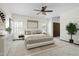 Spacious main bedroom featuring a large bed, ceiling fan, neutral decor, and ample natural light at 14401 N 60Th Pl, Scottsdale, AZ 85254