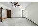 Large main bedroom featuring a ceiling fan, neutral carpeting, and ample natural light through shuttered windows at 14401 N 60Th Pl, Scottsdale, AZ 85254