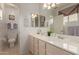 Bright bathroom featuring double sinks, white cabinets, a large mirror, and tile floors at 1549 E Westchester Dr, Chandler, AZ 85249