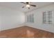 Clean bedroom with neutral color scheme, two windows with plantation shutters, and laminate flooring at 1549 E Westchester Dr, Chandler, AZ 85249