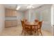 Bright breakfast nook featuring a round wooden table with seating for four, cabinets, and natural light from shuttered windows at 1549 E Westchester Dr, Chandler, AZ 85249