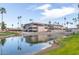 Exterior shot of the clubhouse reflecting in the pond with palm trees in the background on a sunny day at 1549 E Westchester Dr, Chandler, AZ 85249