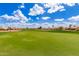 Expansive green golf course fairway under a bright blue sky with puffy clouds, showcasing the community's recreational space at 1549 E Westchester Dr, Chandler, AZ 85249