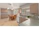 Well-lit kitchen and breakfast nook with a dining table, neutral cabinets, and ample counter space at 1549 E Westchester Dr, Chandler, AZ 85249