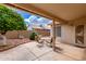 Covered patio with stone floor, outdoor seating, and views of the landscaped backyard at 1549 E Westchester Dr, Chandler, AZ 85249