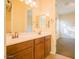 Bathroom features double sinks, wood cabinets, and tile flooring, offering functionality and style at 16089 W Harvard St, Goodyear, AZ 85395