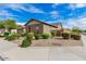 Charming single-story home featuring a two-car garage, desert landscaping, and mature trees at 16089 W Harvard St, Goodyear, AZ 85395