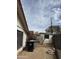 Exterior view of the home's backyard, featuring a shed, alley fence and mature landscaping at 1616 E Pecan Rd, Phoenix, AZ 85040