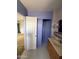 Bathroom area with light purple walls, vanity with sink, and open closet storage at 1616 E Pecan Rd, Phoenix, AZ 85040