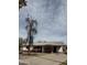 Charming single-story home featuring a covered carport, blooming bougainvillea and front tree at 1616 E Pecan Rd, Phoenix, AZ 85040