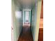 Hallway in light green paint with hardwood floors and multiple doors visible at 1616 E Pecan Rd, Phoenix, AZ 85040