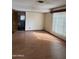 Open concept living room with wood-look flooring and a large window bringing in plenty of light at 1616 E Pecan Rd, Phoenix, AZ 85040