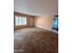 Living room with dated carpet and natural lighting, featuring a window at 1616 E Pecan Rd, Phoenix, AZ 85040