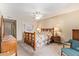 Bright bedroom featuring ceiling fan, carpeted floors, a wooden bed frame and artwork on the wall at 1632 Leisure World --, Mesa, AZ 85206