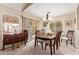 Traditional dining room featuring hardwood table set with a bright chandelier and natural light at 1632 Leisure World --, Mesa, AZ 85206