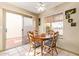 Sunny breakfast nook featuring a wood table, ceiling fan, and sliding glass doors at 1632 Leisure World --, Mesa, AZ 85206