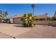 Street view of a single-story home featuring a two-car garage, desert landscaping, and a brick trimmed driveway at 1632 Leisure World --, Mesa, AZ 85206