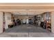 Spacious garage with ample storage shelves, bikes, a ladder and sporting equipment at 1632 Leisure World --, Mesa, AZ 85206