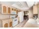 Eat-in kitchen with beige cabinets, white appliances, and a view into dining room at 1632 Leisure World --, Mesa, AZ 85206