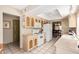 Eat-in kitchen with beige cabinets, white appliances, and a view into dining room at 1632 Leisure World --, Mesa, AZ 85206