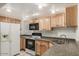 Well-lit kitchen with updated appliances, light wood cabinets, and durable countertops at 16402 N 31St St # 107, Phoenix, AZ 85032