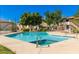 Community pool surrounded by lush greenery, landscaping and blue skies at 16402 N 31St St # 107, Phoenix, AZ 85032