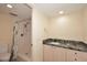 Cozy bathroom featuring a granite countertop, stylish cabinets, a walk-in shower, and modern fixtures at 16920 E Monterey Dr, Fountain Hills, AZ 85268