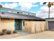 Modern home with a brick accent wall, steel roof, and a bright blue front door at 16920 E Monterey Dr, Fountain Hills, AZ 85268