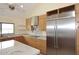 Modern kitchen featuring light wood cabinetry and stainless steel refrigerator at 16920 E Monterey Dr, Fountain Hills, AZ 85268