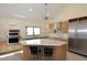 Gorgeous kitchen with island featuring a marble countertop and stainless steel appliances at 16920 E Monterey Dr, Fountain Hills, AZ 85268