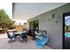 Covered patio featuring a dining table, chairs, and a blue egg chair, perfect for outdoor relaxation and entertainment at 16920 E Monterey Dr, Fountain Hills, AZ 85268