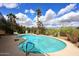 Backyard pool featuring clear water, palm trees, and a concrete deck under a sunny sky with fluffy clouds at 16920 E Monterey Dr, Fountain Hills, AZ 85268