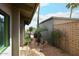 Cozy side yard featuring a stone paver walkway, gravel, lush greenery and desert views at 16920 E Monterey Dr, Fountain Hills, AZ 85268