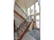 Bright foyer featuring an open wood staircase with metal railings and large windows providing abundant natural light at 16920 E Monterey Dr, Fountain Hills, AZ 85268