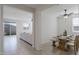 Bright dining area featuring a modern table and chairs, with a living room view at 17487 W Daley Ln, Surprise, AZ 85387