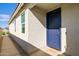 Close up of the home's entryway showcasing a blue front door, stucco, and a 'so blessed' doormat at 17487 W Daley Ln, Surprise, AZ 85387