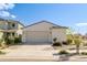 Single-story stucco home with desert landscaping, a neutral color palette, and a concrete driveway at 17487 W Daley Ln, Surprise, AZ 85387