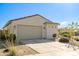 Charming single-story home showcasing a two-car garage, desert landscaping, and a tile roof at 17487 W Daley Ln, Surprise, AZ 85387