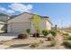 Single-story stucco home with a neutral color palette, desert landscaping, and an attached garage at 17487 W Daley Ln, Surprise, AZ 85387