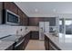 Contemporary kitchen featuring stainless appliances, white subway tile backsplash, and granite countertops at 17487 W Daley Ln, Surprise, AZ 85387