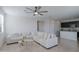 Spacious living room showcasing a sectional sofa, tile flooring, and ample natural light at 17487 W Daley Ln, Surprise, AZ 85387