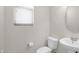 Small bathroom features tile flooring, a toilet, and a window for natural light at 17655 W Tasha Dr, Surprise, AZ 85388