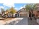 Charming two-story home featuring a three-car garage and well-maintained landscaping in a residential neighborhood at 17655 W Tasha Dr, Surprise, AZ 85388