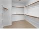 Walk-in closet with built-in shelving and neutral carpeting at 17655 W Tasha Dr, Surprise, AZ 85388