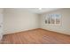 Bright and airy bedroom with wood floors and large window with plantation shutters at 18018 N Highwood Ct, Sun City, AZ 85373