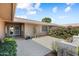 Welcoming entrance featuring a tiled walkway, lush greenery, and a glimpse of the home's architectural details at 18018 N Highwood Ct, Sun City, AZ 85373